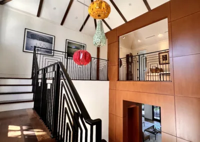 A staircase in a home with a wooden ceiling.